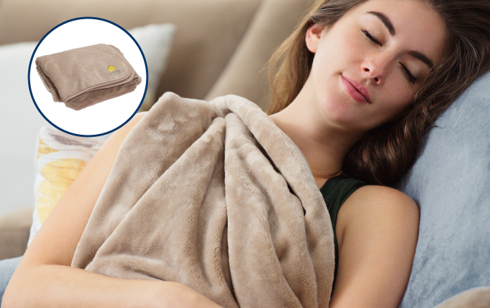 Woman using small massage gun on shoulders